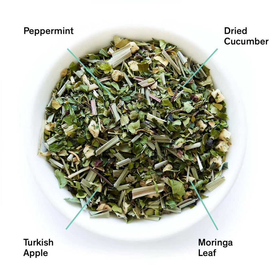  bowl of dried herbs with labels for peppermint, dried cucumber, Turkish apple, and moringa leaf