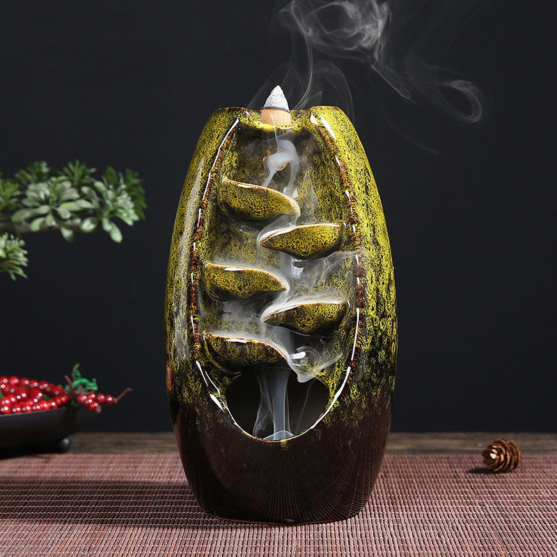 Decorative incense burner with smoke on a dark background