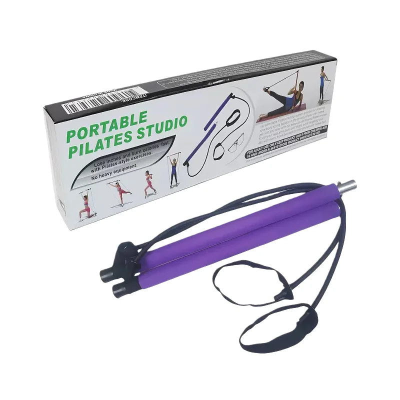 A purple and black Pilates resistance band with a wrist strap, shown next to its white and black retail packaging box labeled 'PORTABLE PILATES STUDIO'.