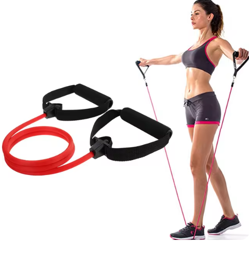 A red resistance band with black foam handles is shown alongside a woman in athletic wear using the band for exercise against a plain white background.