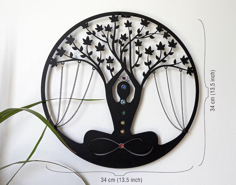 Decorative wall art of a tree with branches and hanging elements on a white background