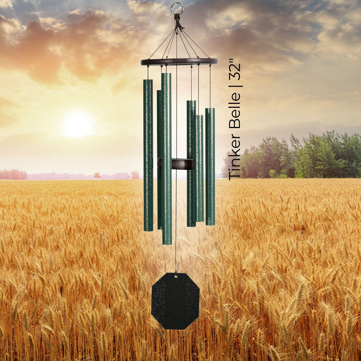 Wind chime with 'Tinker Belle 32' text against a sunset over a field background