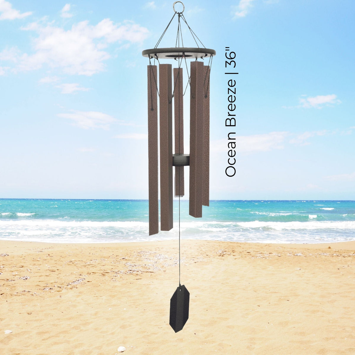Wind chime labeled 'Ocean Breeze 36"' on a beach with ocean view