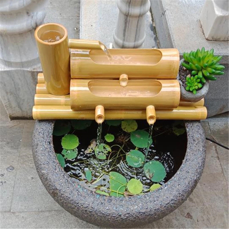 Handcrafted Bamboo Water Spout sitting on top of a container of water.