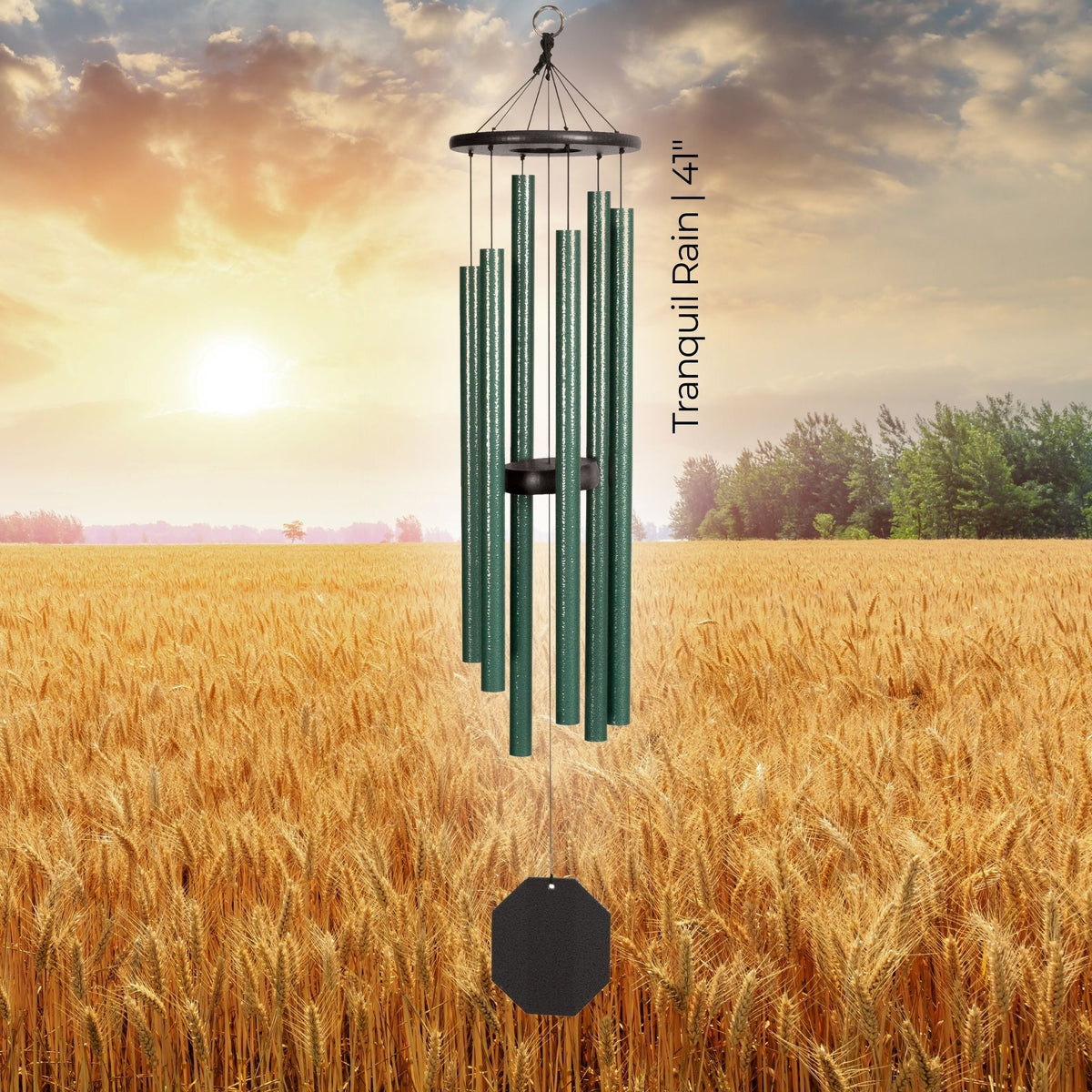 Wind chime in a field with a sunset background