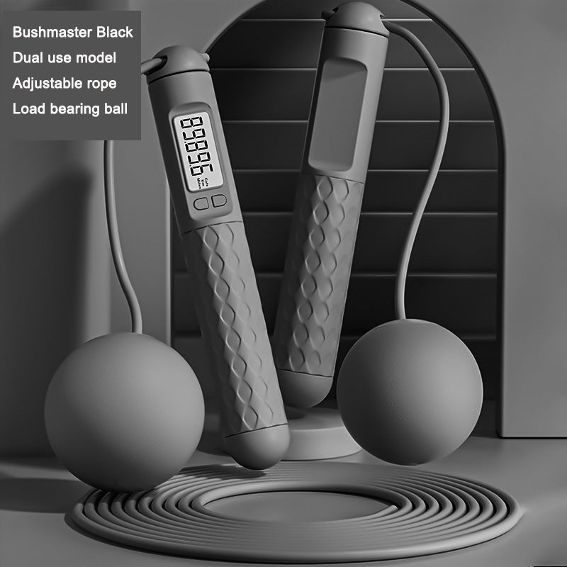 Gray jump rope with digital display and load bearing balls on a dark background