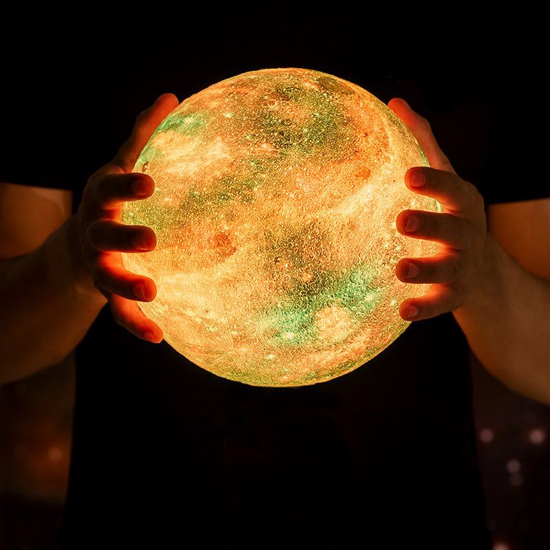 Holding a glowing moon-shaped object against a dark background