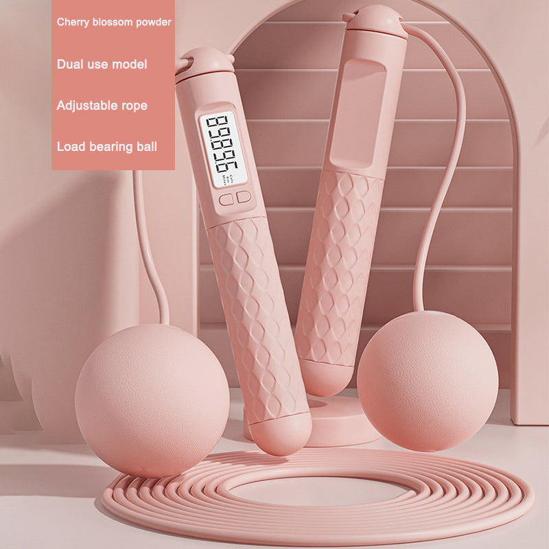 Pink jump rope with digital display on a light pink background