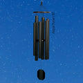 Black wind chime against a blue sky with white stars