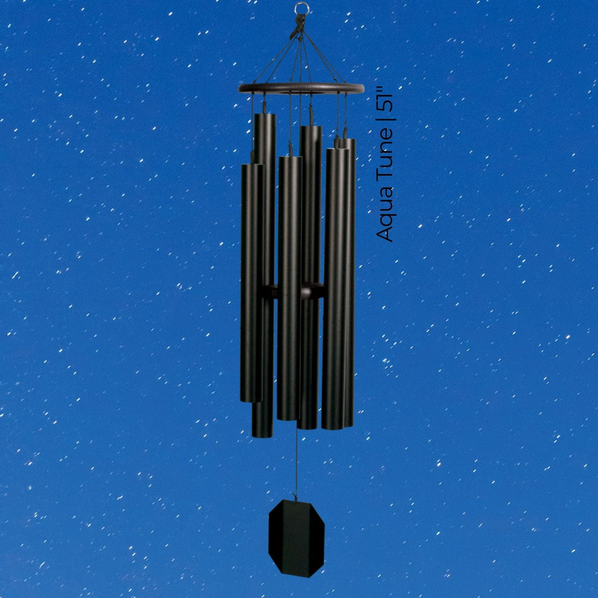 Black wind chime against a blue sky with white stars