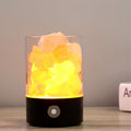 Salt lamp on a wooden surface and a yellow glow.