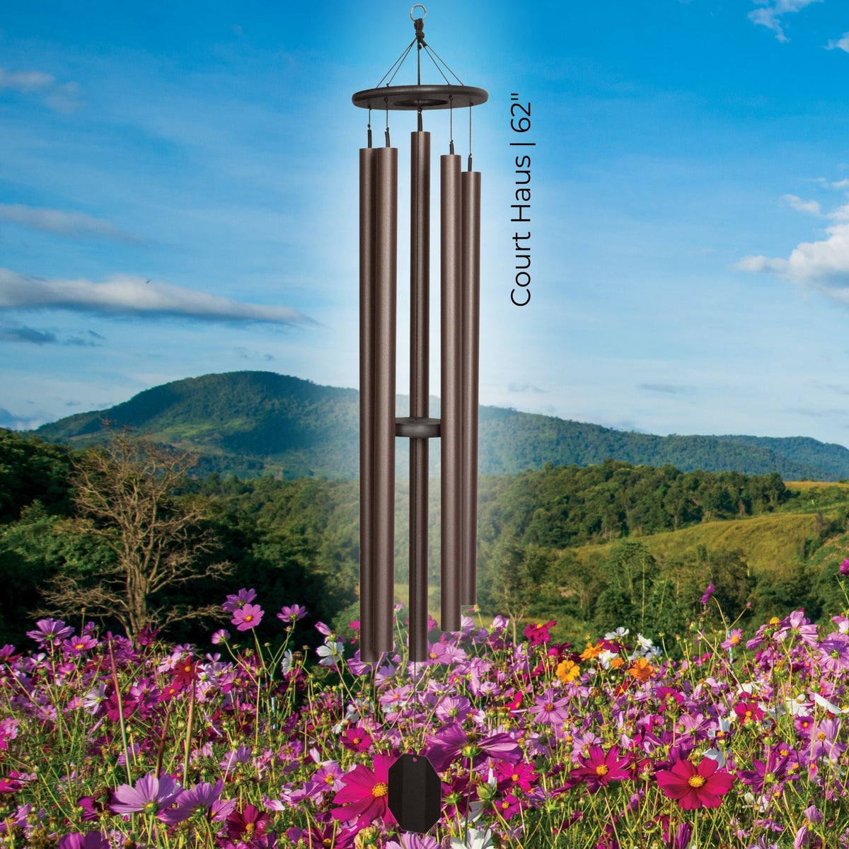 Wind chime with 'Court Haus' branding against a scenic background of mountains and flowers.