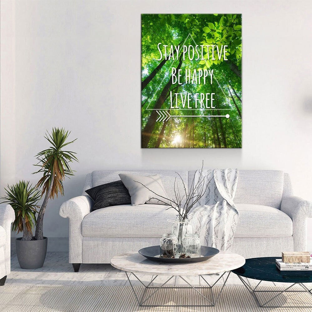 Living room with a gray sofa, coffee table, and motivational wall art.