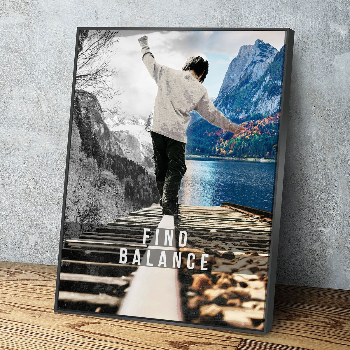 Framed poster of a person on a dock with mountains and water, featuring the text 'Find Balance'.