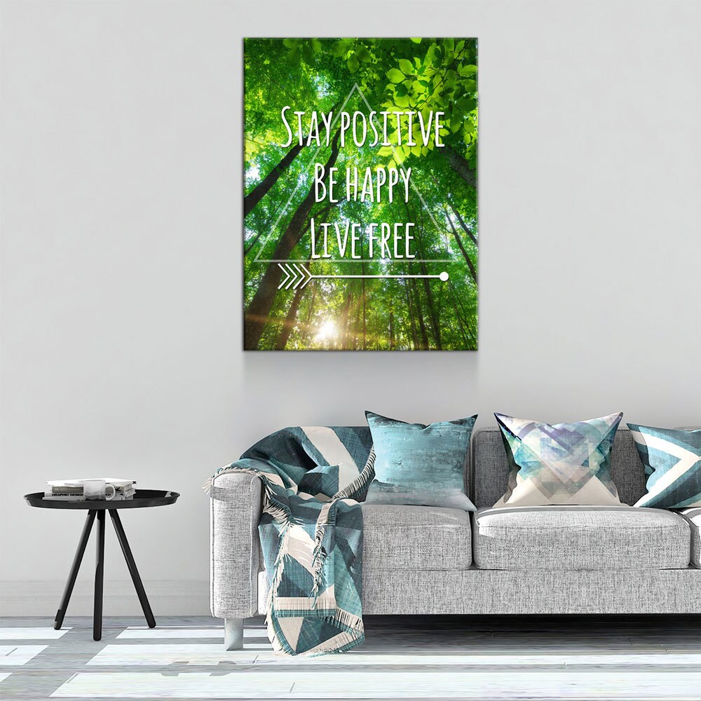 Canvas print with motivational quote above a sofa in a living room