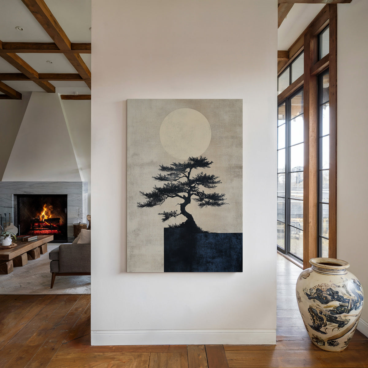 Modern living room with a painting of a tree and moon, a vase on a table, and a fireplace.