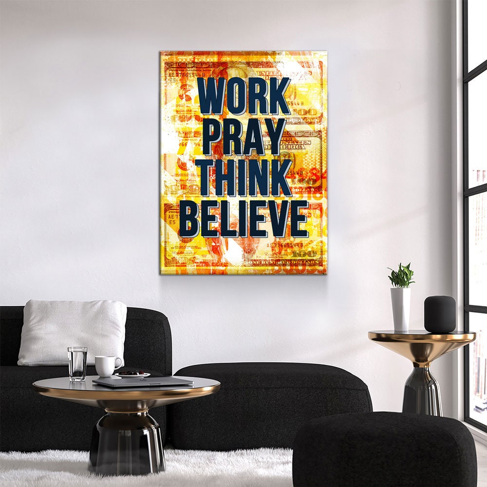 Decorative wall art with motivational quote in a modern living room.