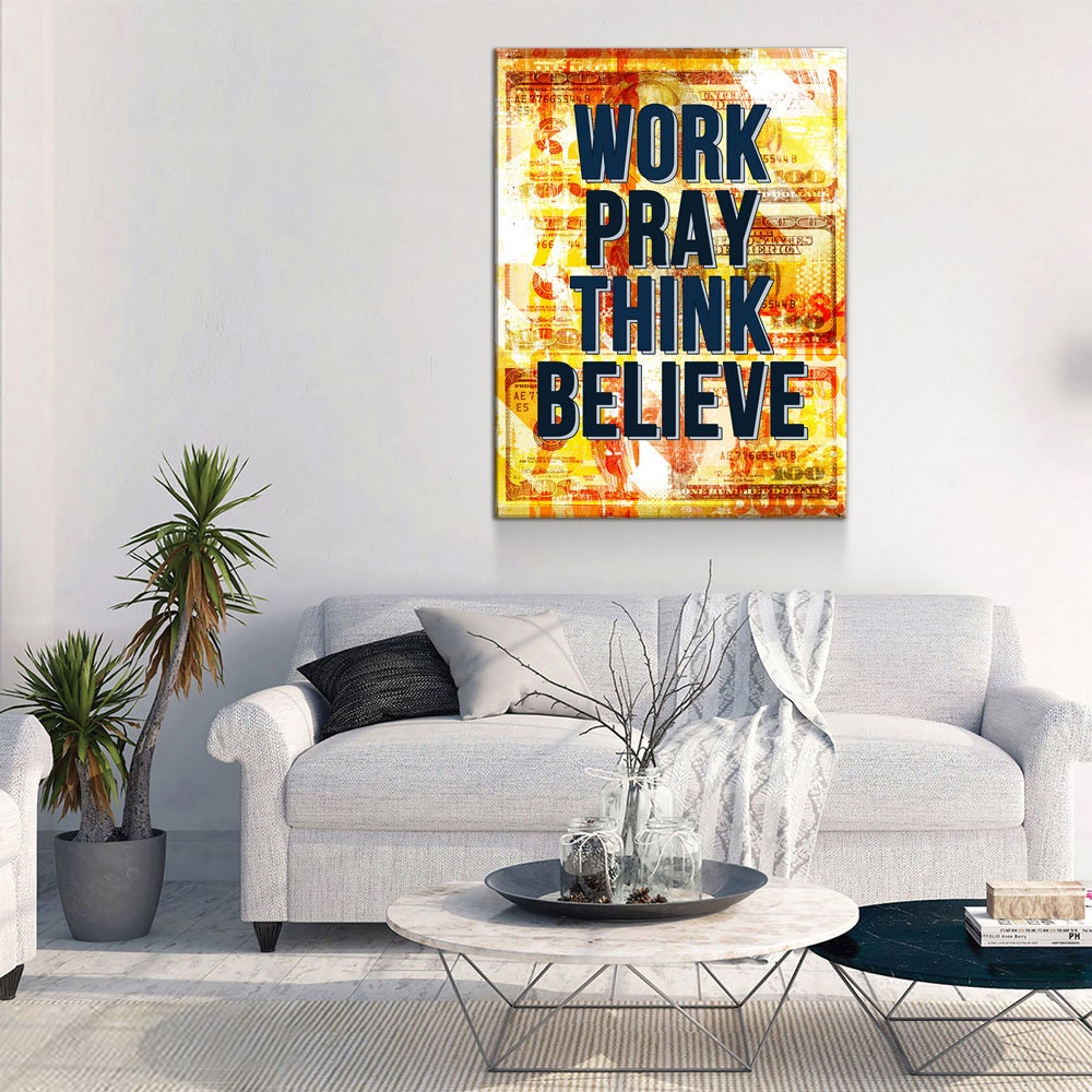 Living room with a motivational poster on the wall, featuring the text 'Work Pray Think Believe'.
