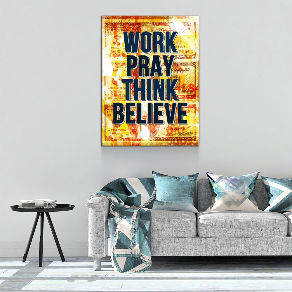 Decorative wall art with motivational quote above a sofa in a living room.
