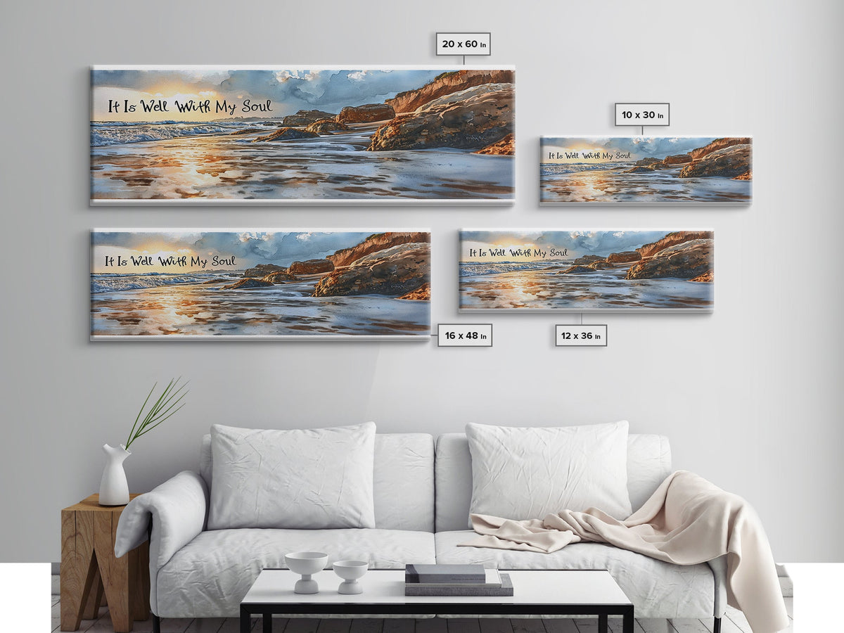 Set of four framed beachscape wall art pieces on a gray wall above a white sofa.