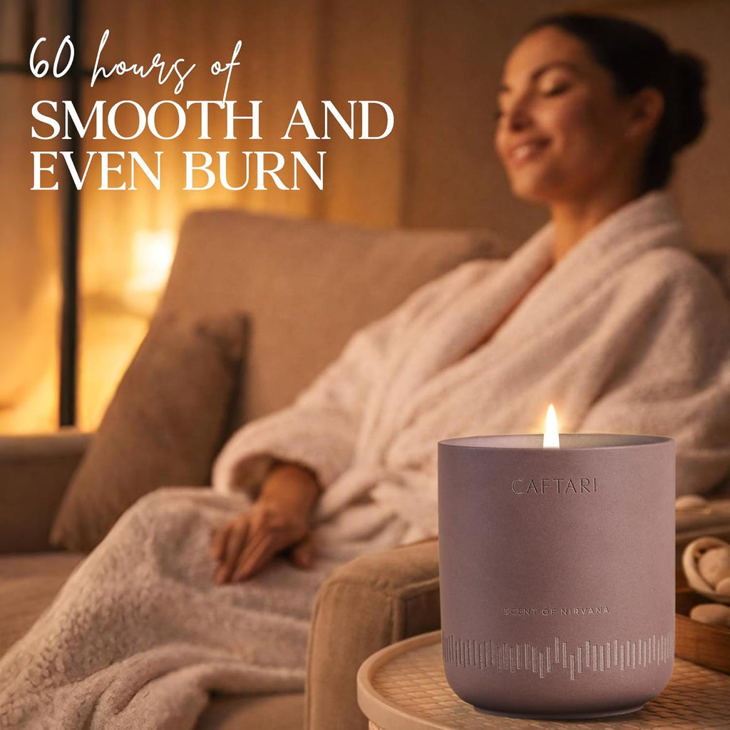 Woman in a robe sitting on a couch with a lit candle in front of her, text '60 hours of smooth and even burn' above.