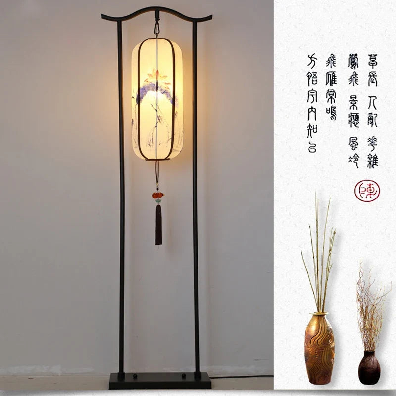 Traditional Chinese floor lamp with decorative lantern and two vases on a white background.