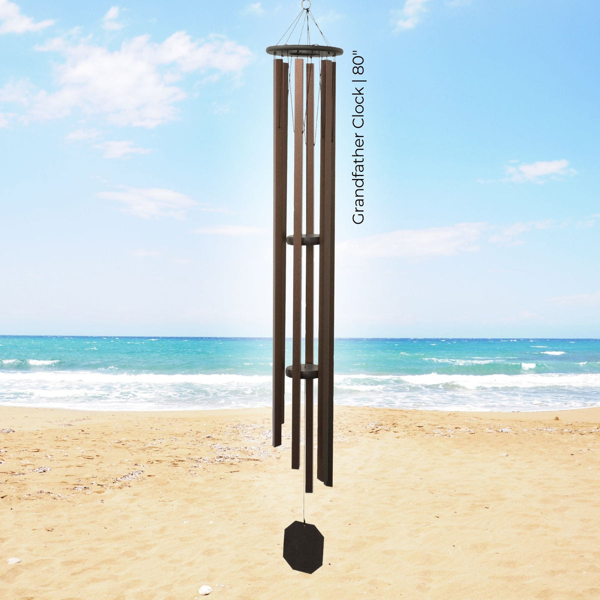 Grandfather clock wind chime on a beach with ocean view