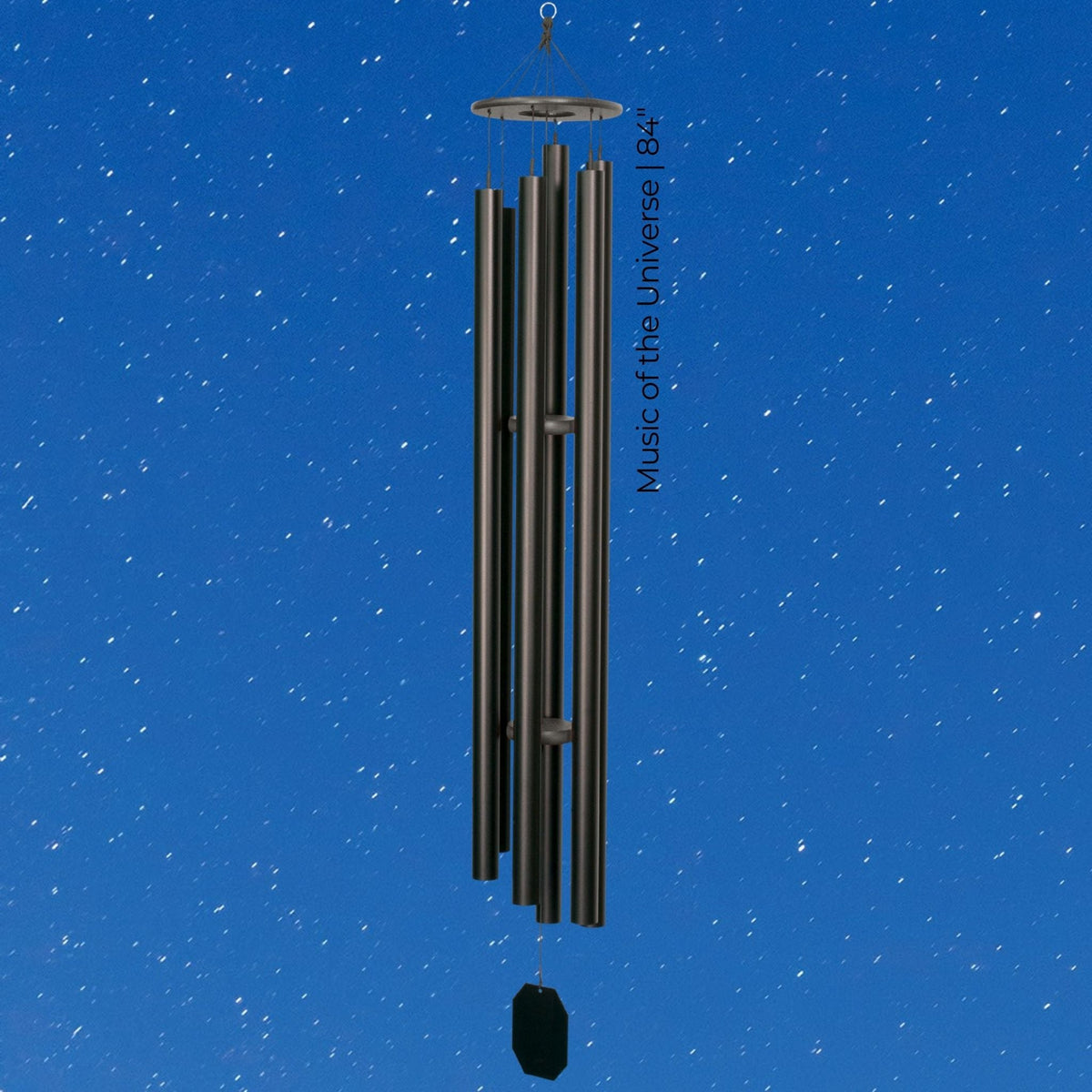 Black wind chime against a blue sky with star-like dots