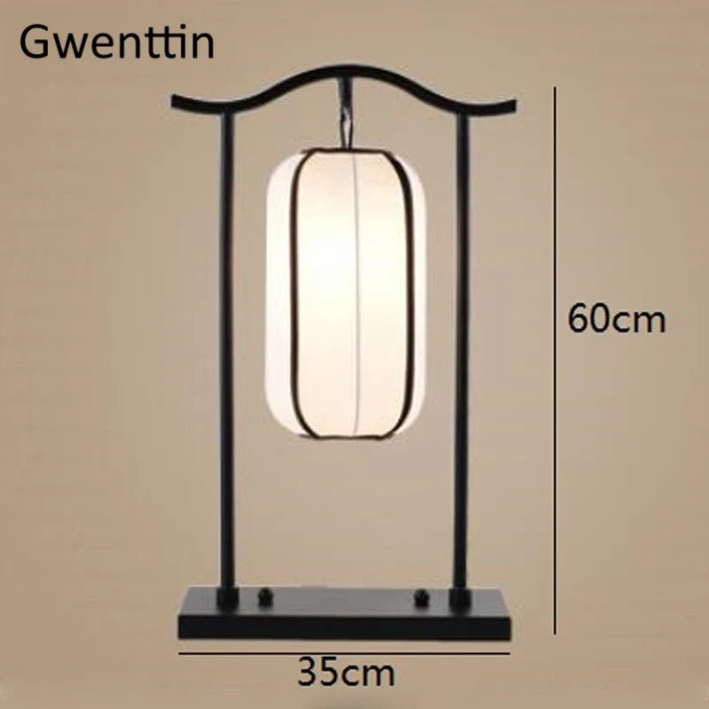 A black metal table lamp with a glowing rectangular white shade, shown on a beige background with dimension labels indicating 60 cm height and 35 cm width. The text 'Gwenttin' appears at the top left.