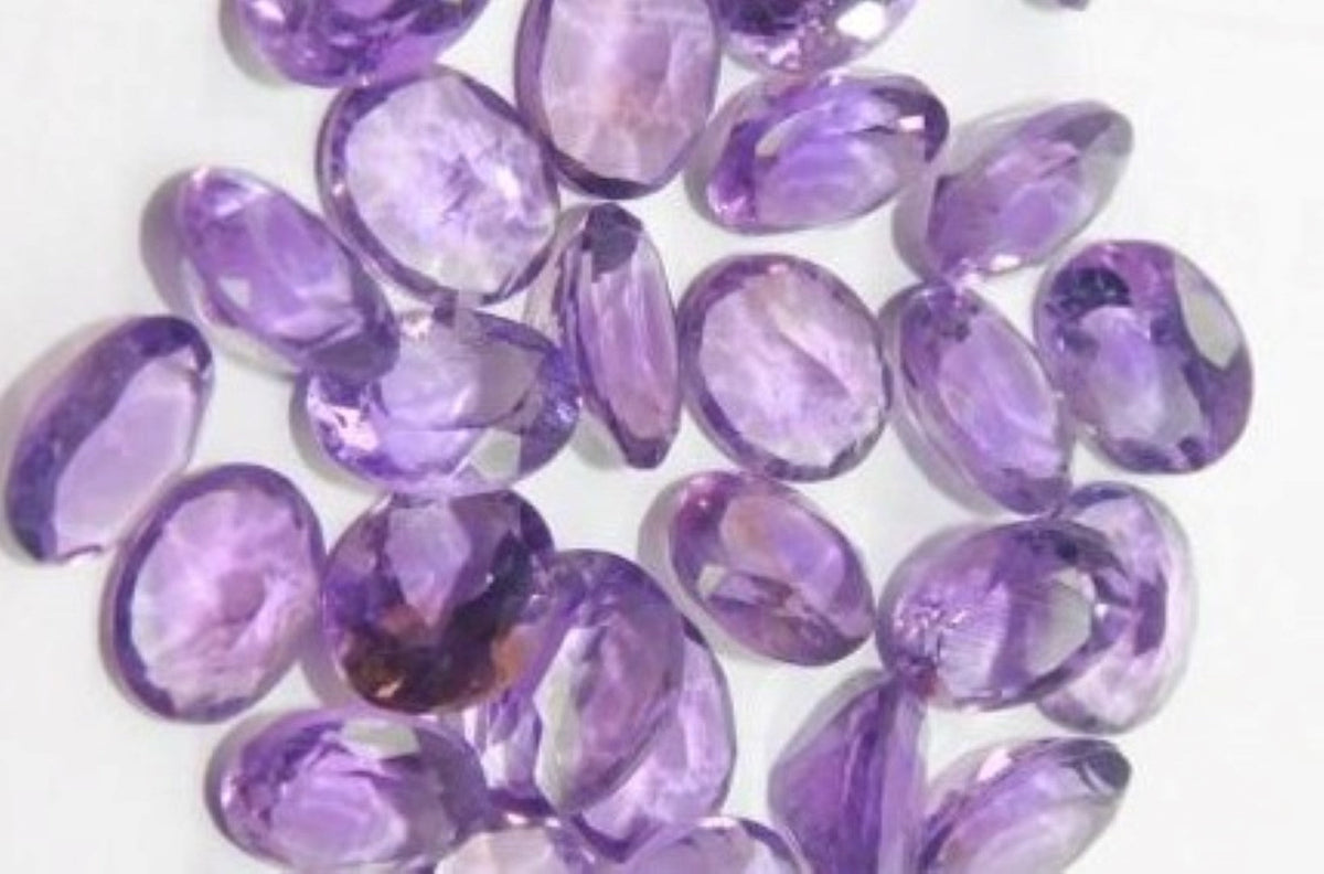 Several Brazilian amethysts in an elegant oval cut on a white background
