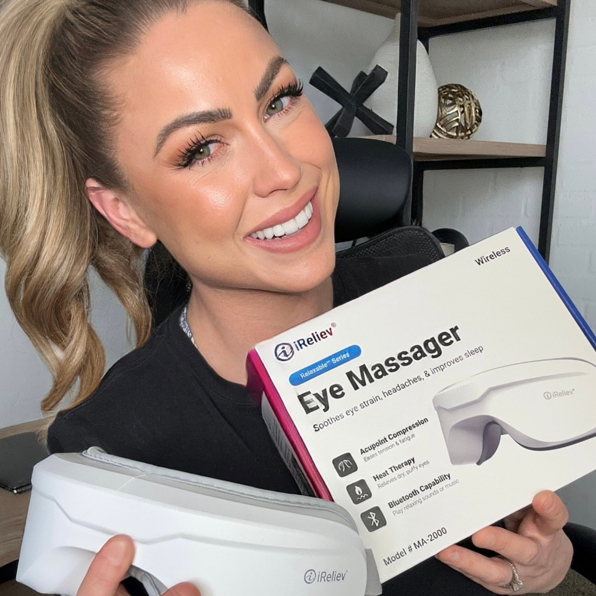 Woman holding an iReliev eye massager and its packaging