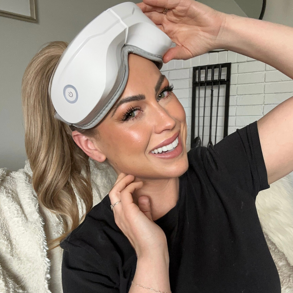 Woman wearing a white headband device, possibly for hair care or treatment, in a home setting.