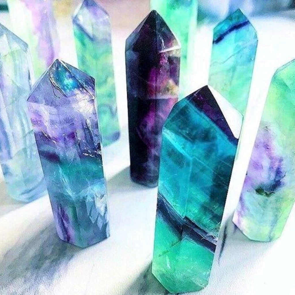 Several Fluorite Crystal Obelisk on a white surface.