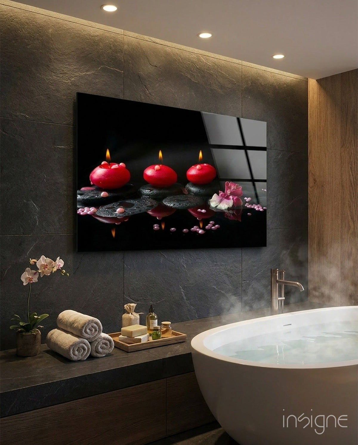 Black glass wall art showing three lit red candles next to a  filled bathtub. 