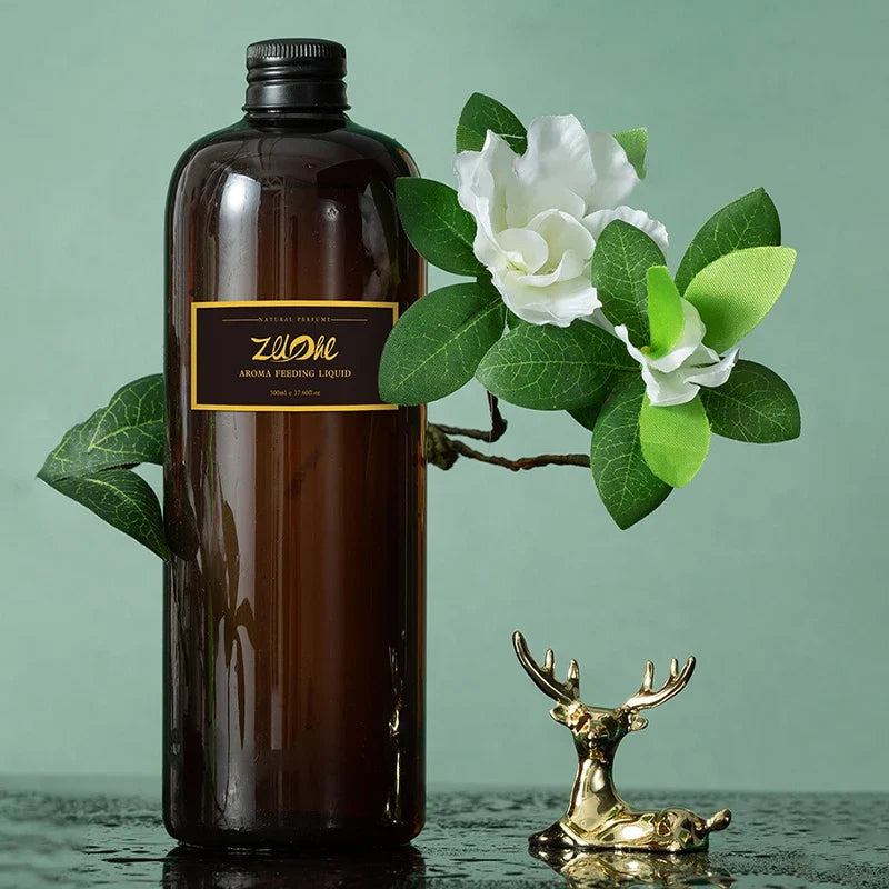 Brown bottle with a label, white flower, green leaves, and gold deer figurine on a light green background