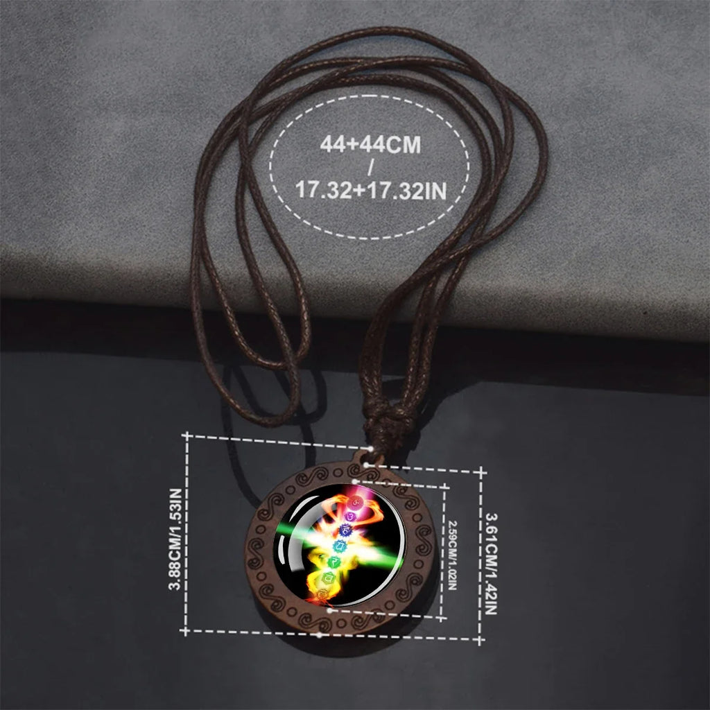A brown cord pendant necklace with a round pendant featuring a colorful chakra symbol on a dark background, shown with overlaid dimension markings for the cord and pendant.