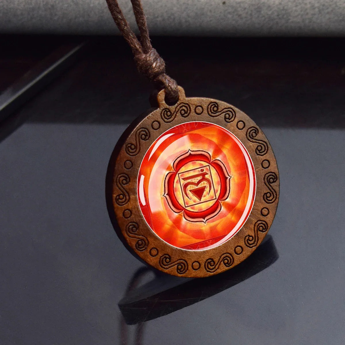 Pendant with a red circular design on a dark surface