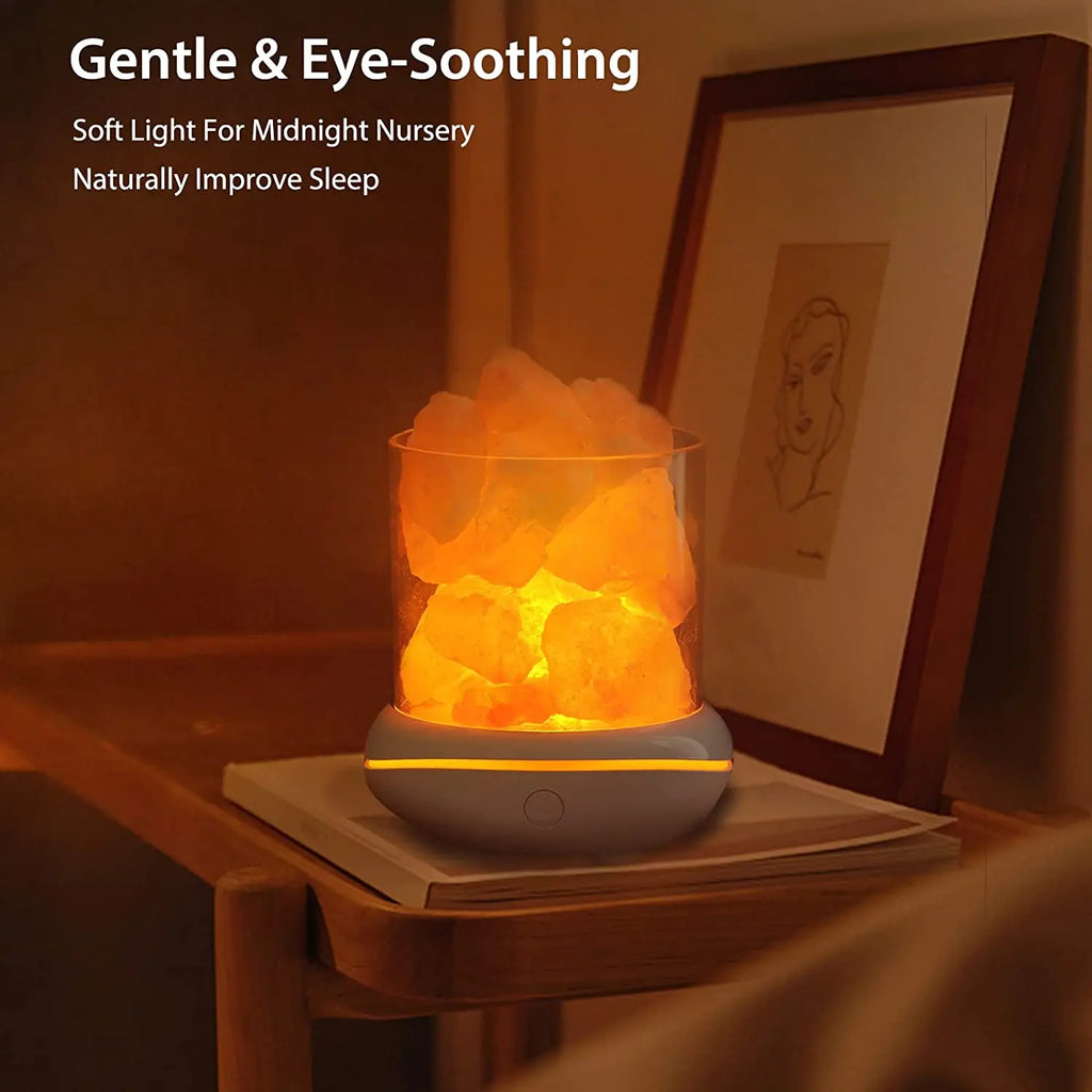 a lighted Natural Himalayan Salt Lamp sitting on a table in front of a portrait