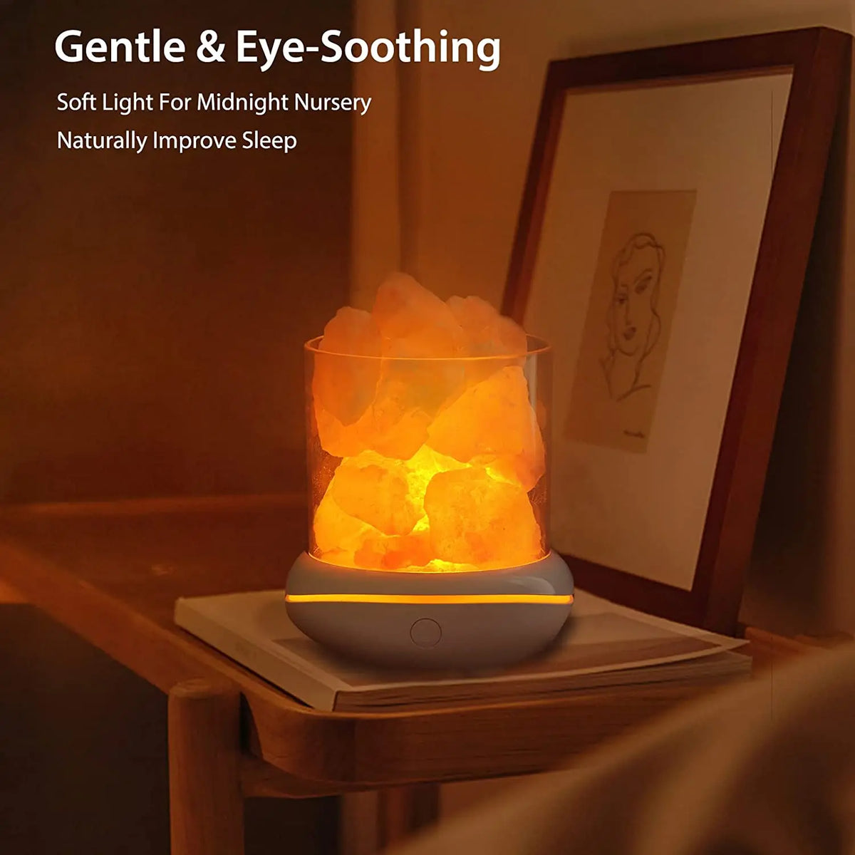a lighted Natural Himalayan Salt Lamp sitting on a table in front of a portrait