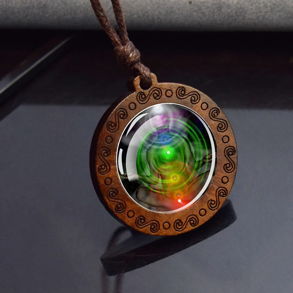Wooden pendant with a colorful swirling design on a dark surface