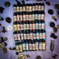 Five rows of essential oils in small bottles.
