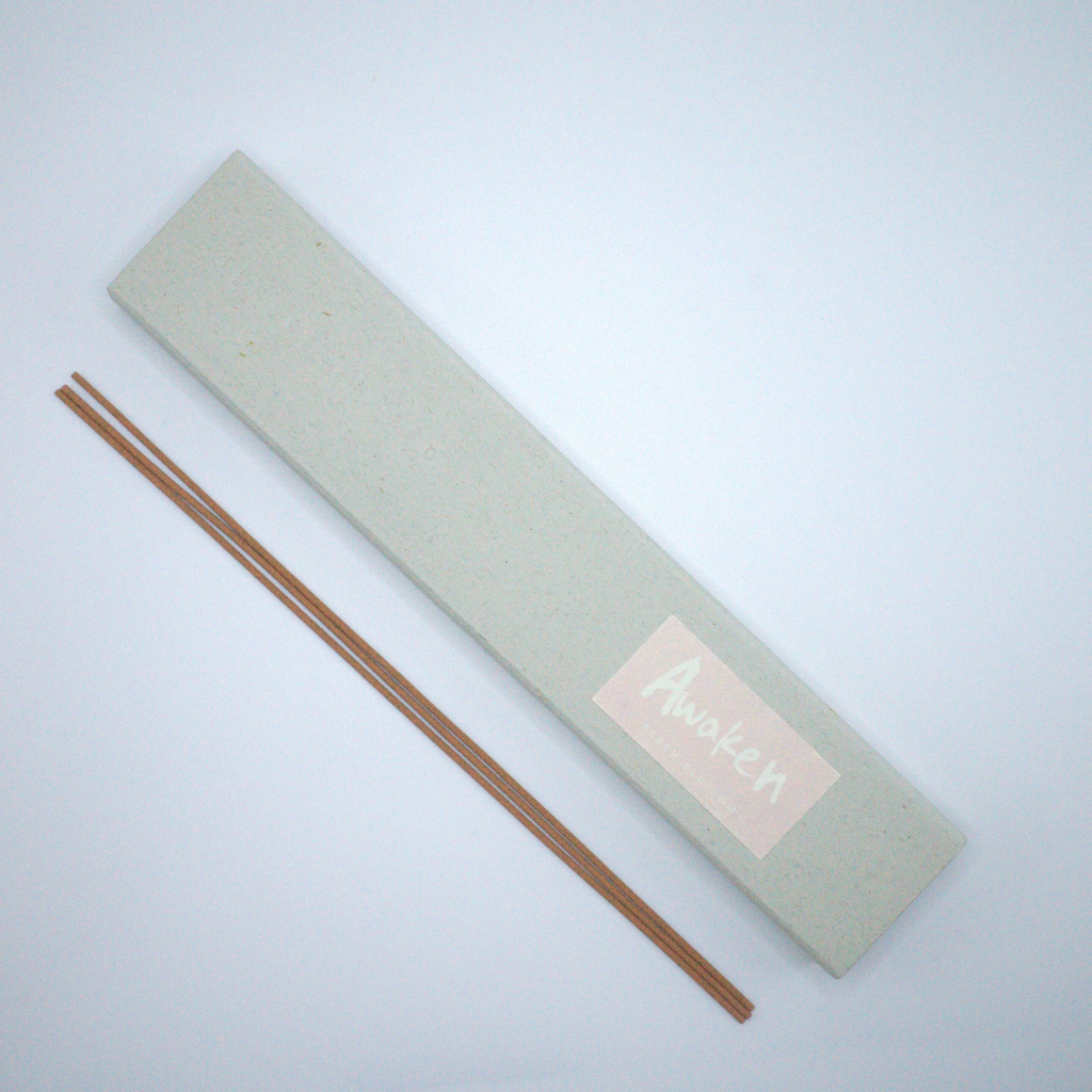 Incense sticks next to an Awaken incense box.