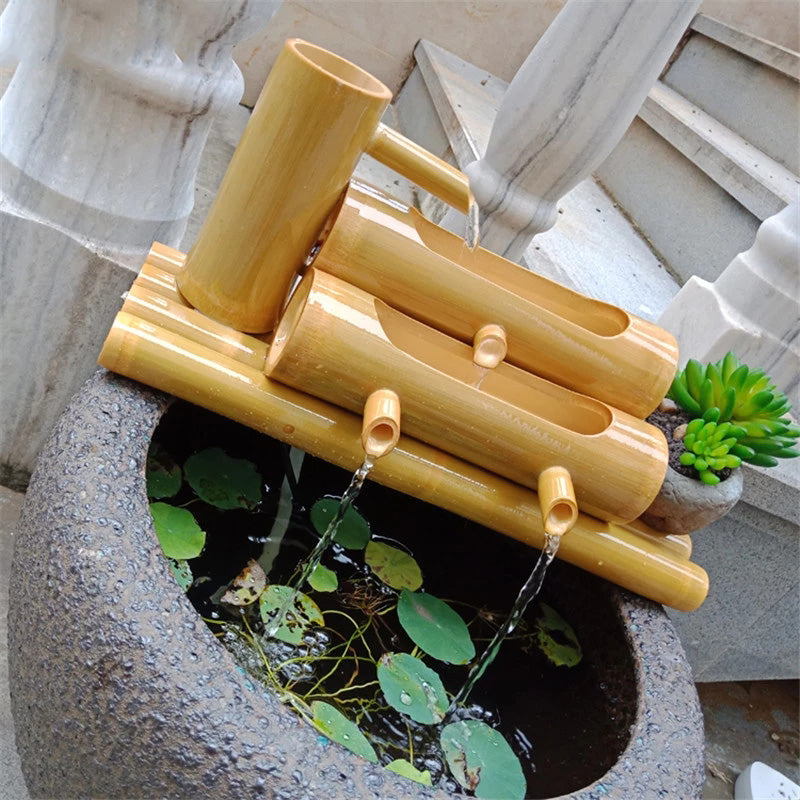 Close-up picture of a Handcrafted Bamboo Water Spout with water flowing out of the channels.