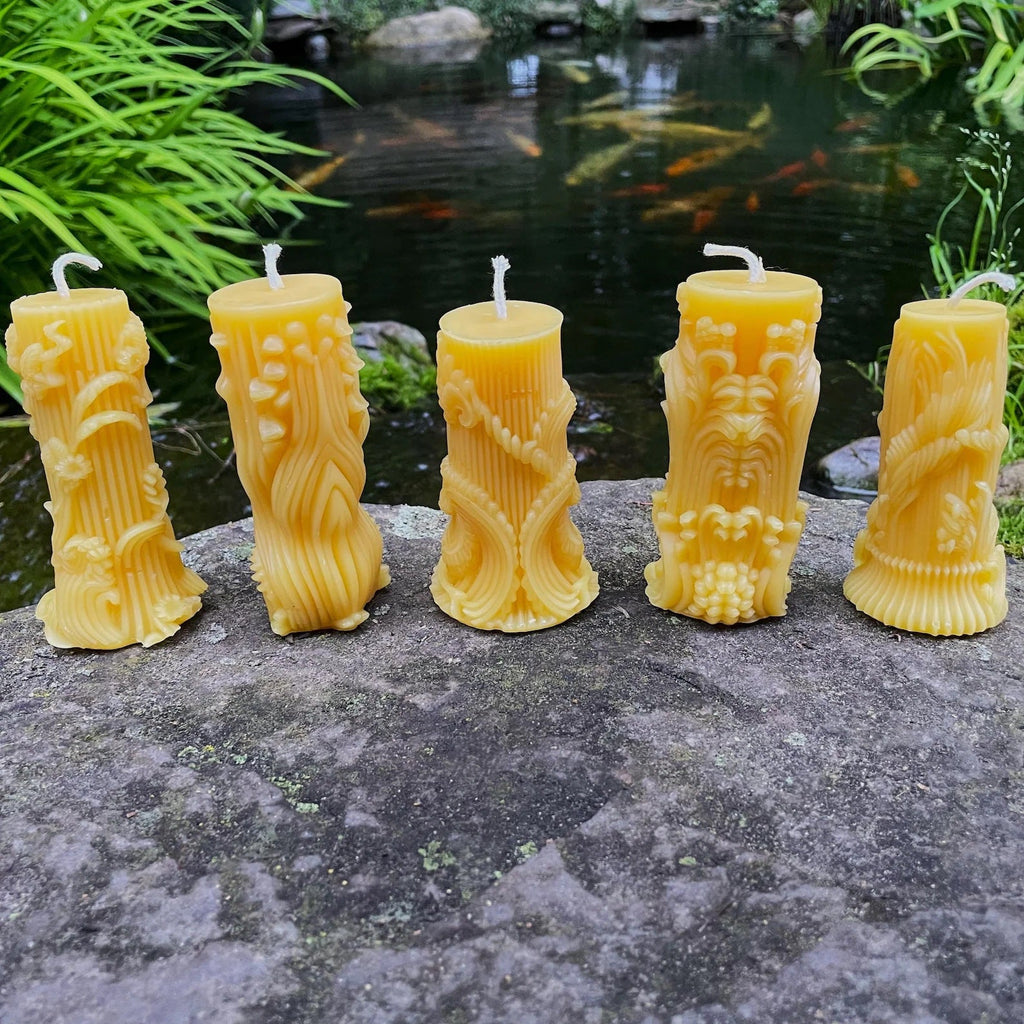 Five carved raised leaf and floral design beeswax candles.
