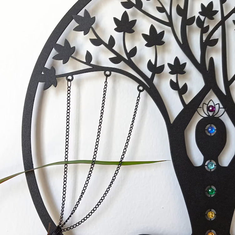Black tree-shaped jewelry holder with hanging necklaces on a white background