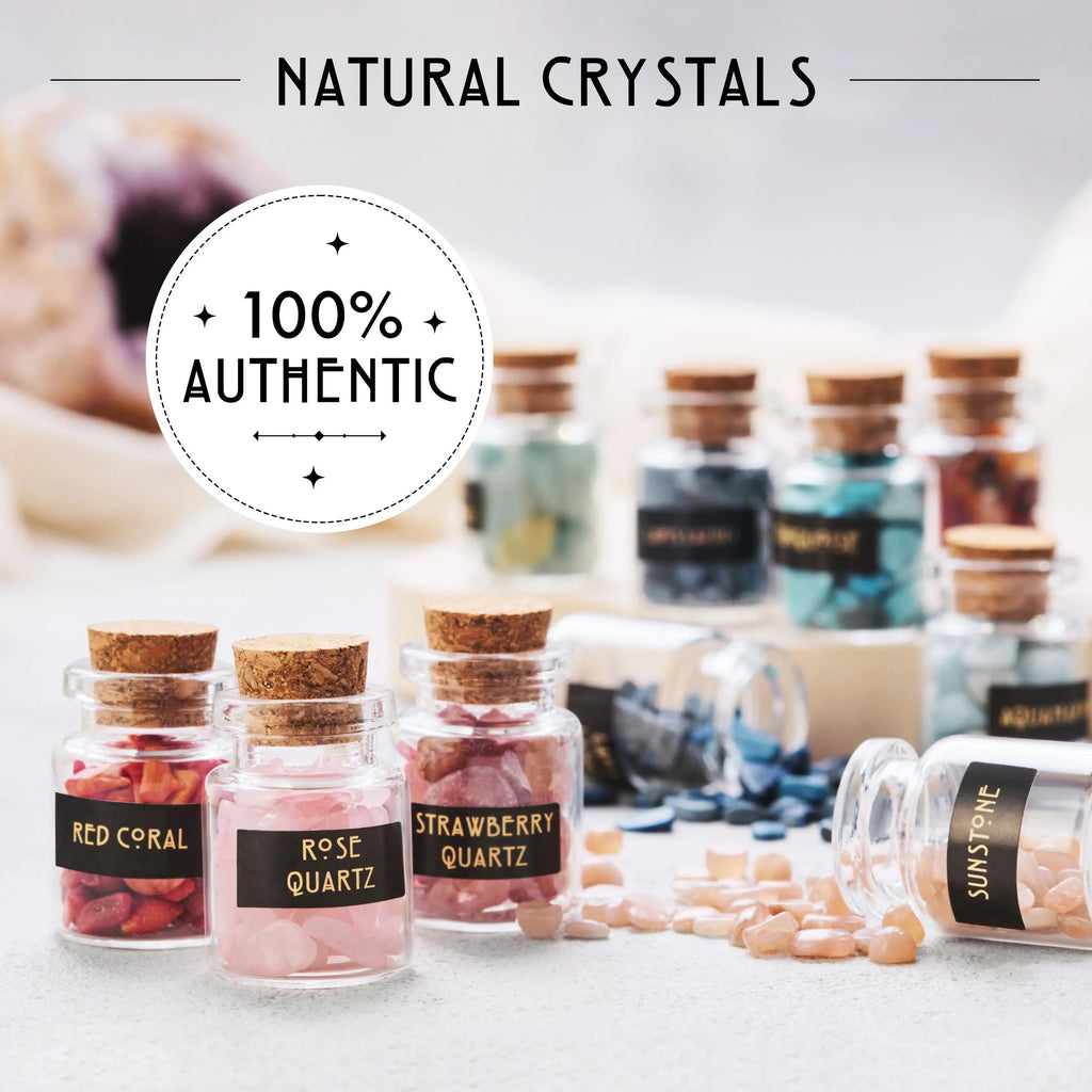 Small glass jars with cork stoppers from the 50 PCS Gemstone Kit containing healing crystals like Red Coral, Rose Quartz, Strawberry Quartz, and Sunstone, with a circular emblem reading 100% Authentic.