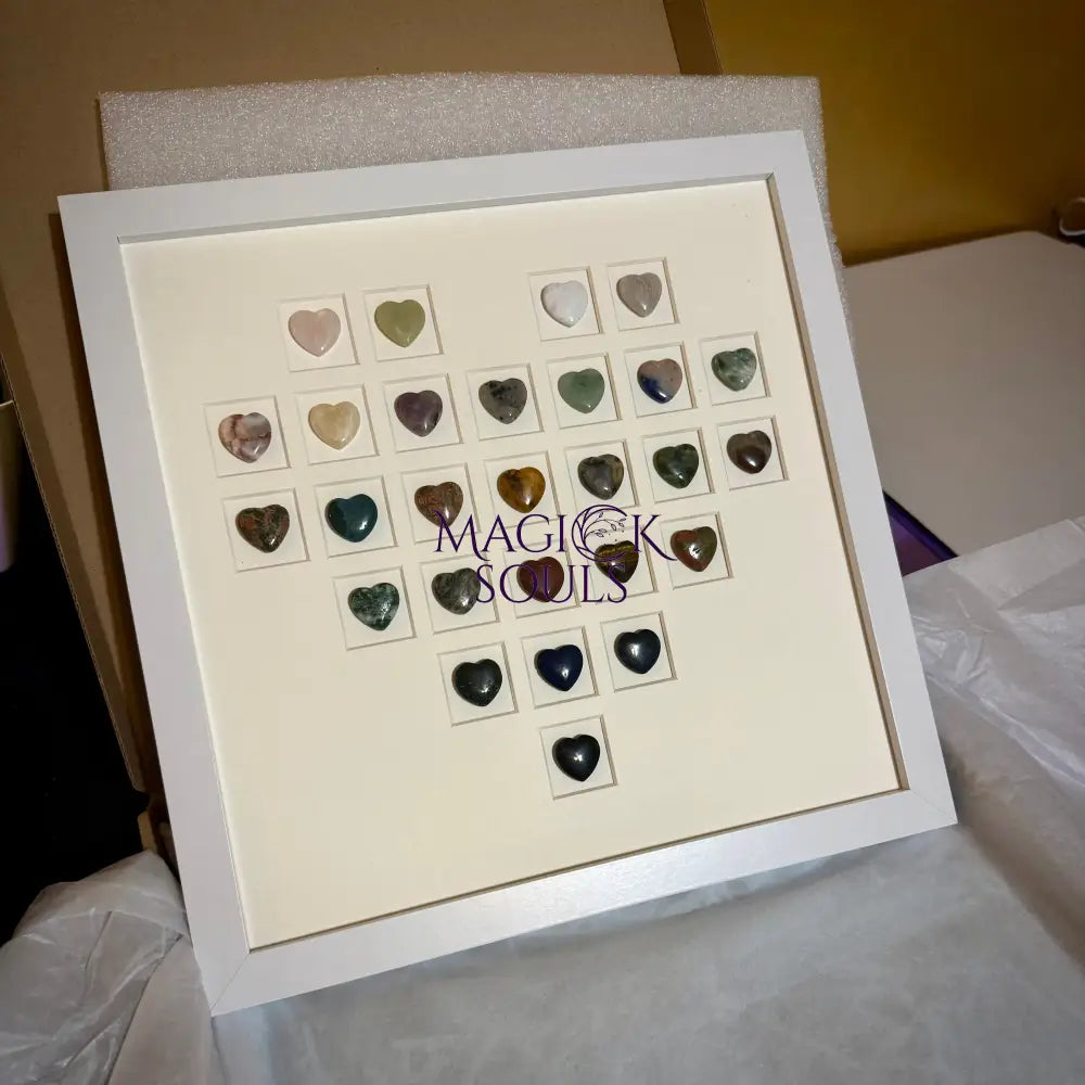 Framed display of heart-shaped stones with 'Magick Souls' branding.