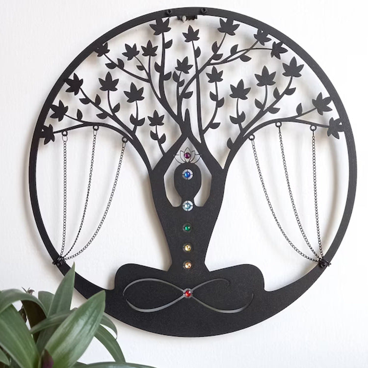 Decorative wall art in the shape of a tree with hanging chains on a white background