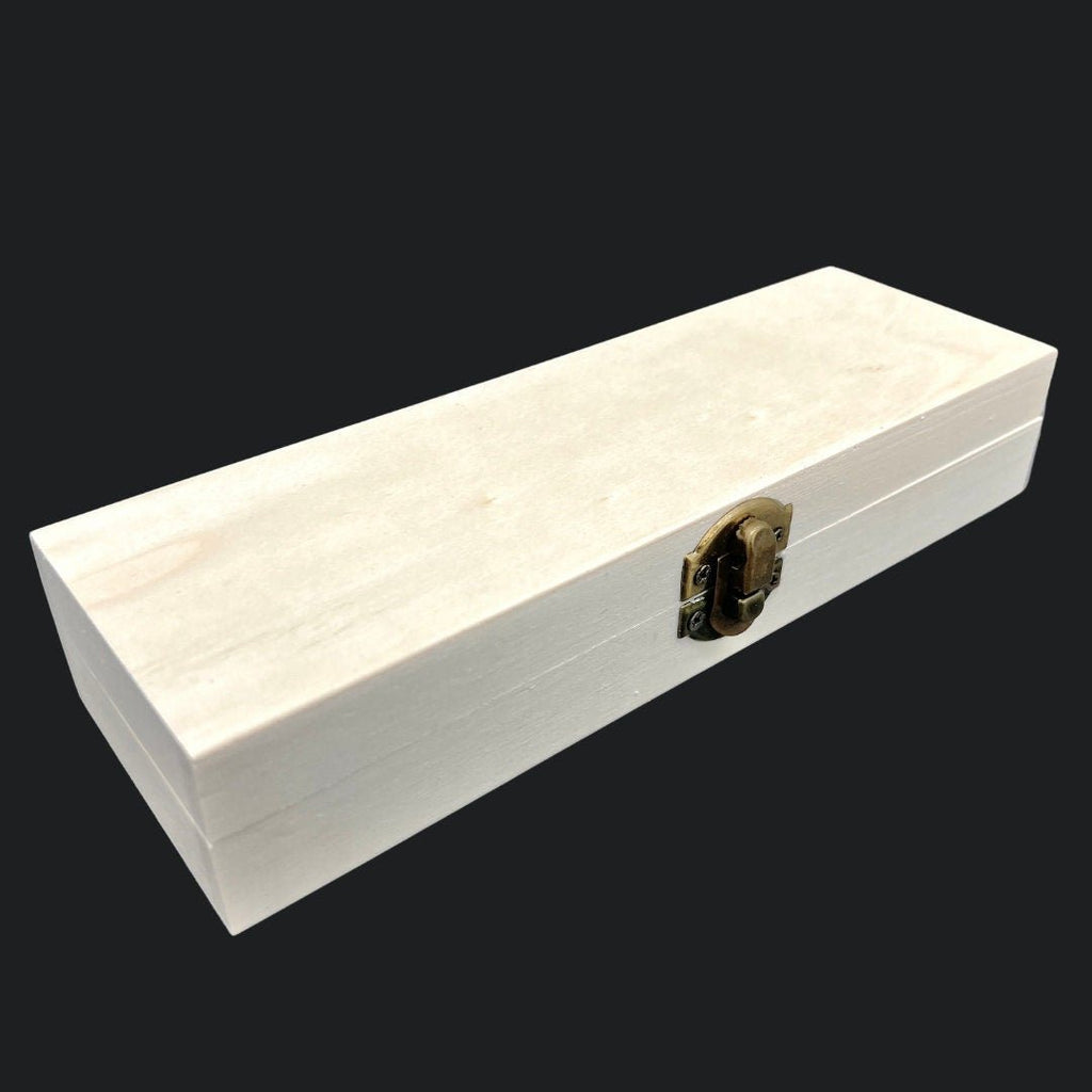 White wooden box with a gold latch on a black background