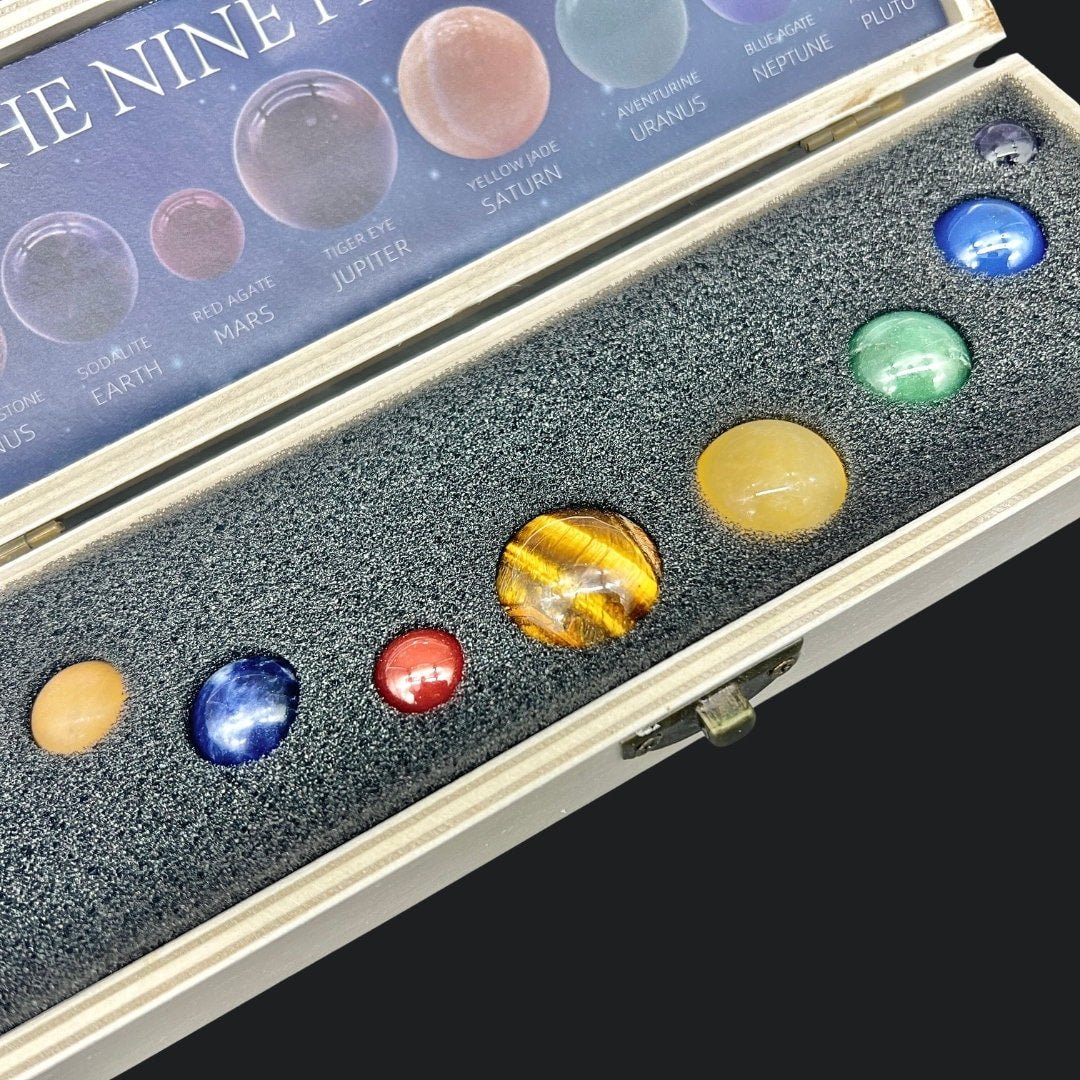 Collection of model planets in a display case with a box labeled 'The Nine Planets'.